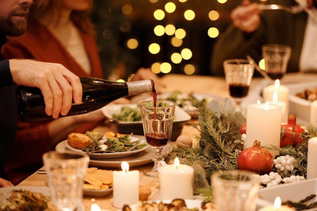 person pouring wine on glass