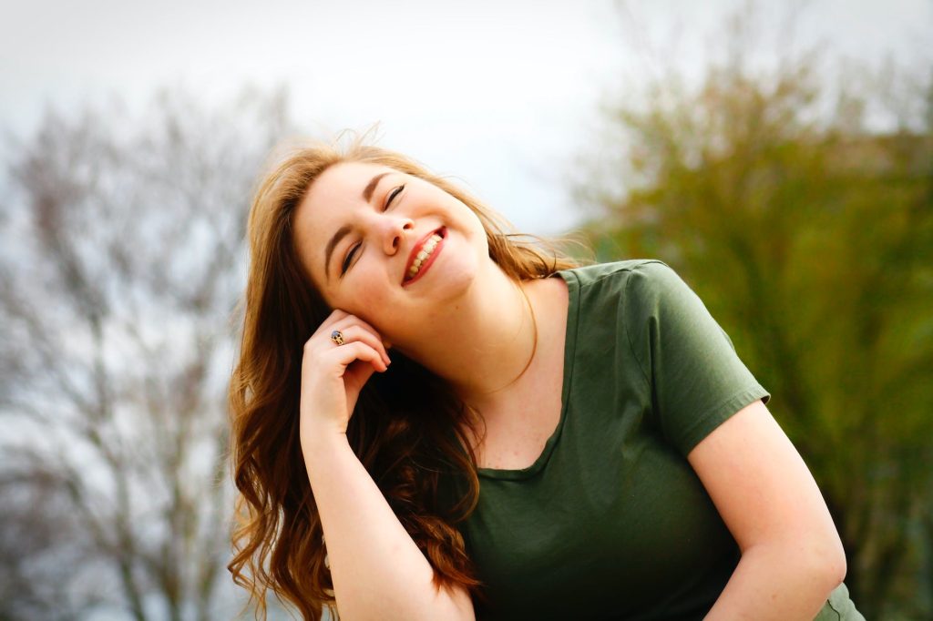 woman in green shirt smiling