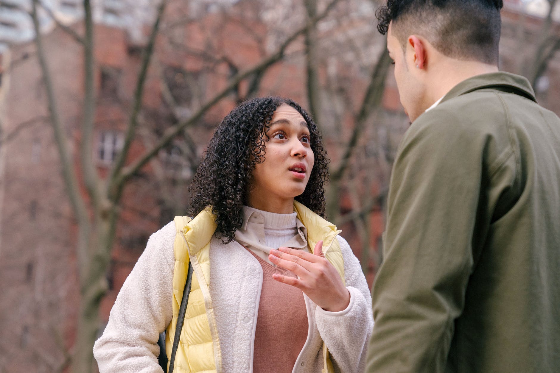 ethnic couple arguing on street in daytime